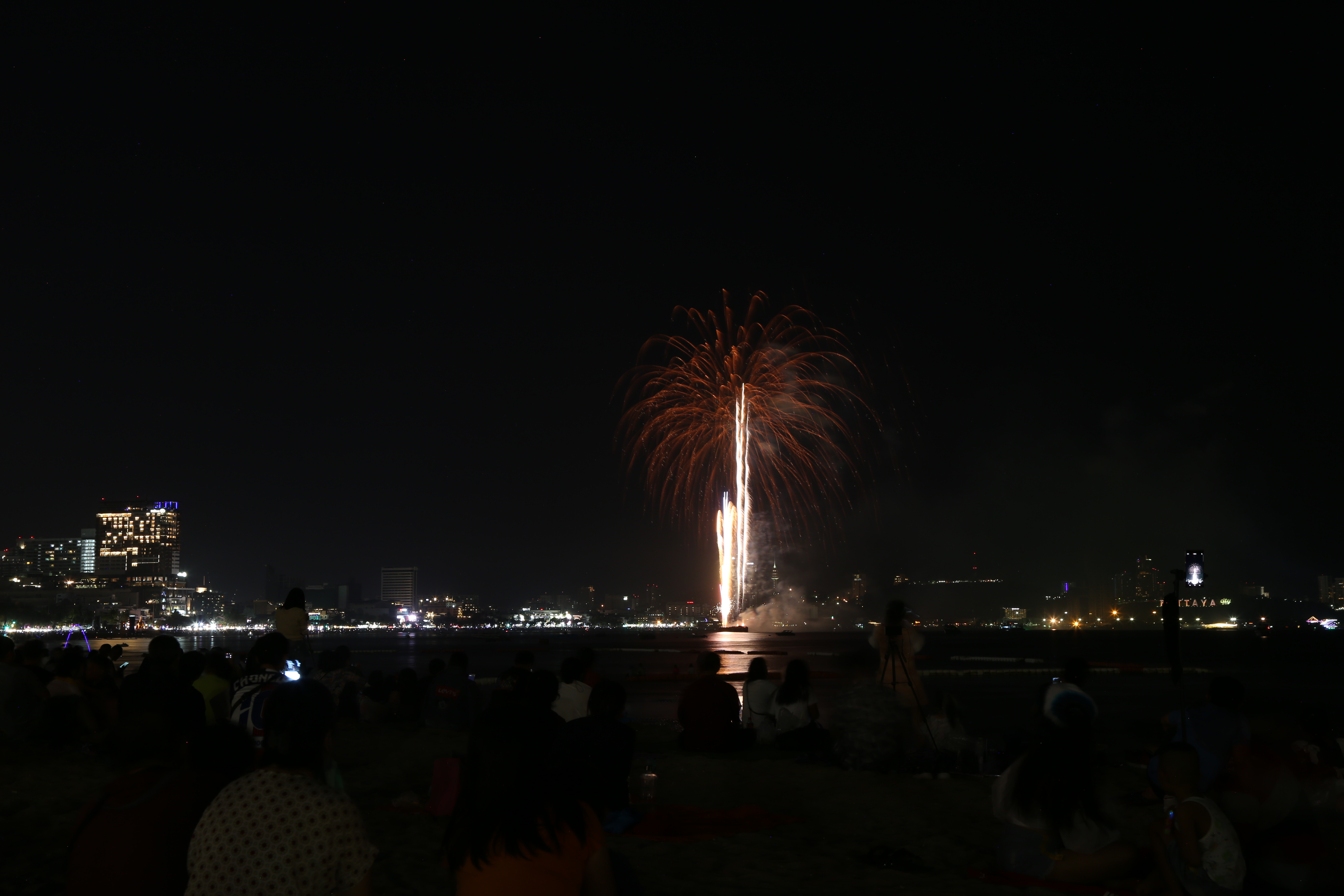 Large fireworks burst over Pattaya beachfront at night